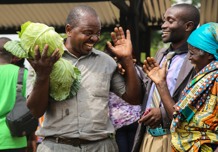 Happy people sharing a plentiful vegetable harvest.